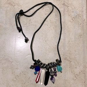 Vintage costume jewelry on braided cotton strands.